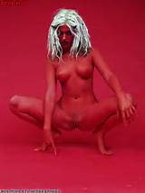 Hot naked blonde girl painted in red and wearing horns of the devil.